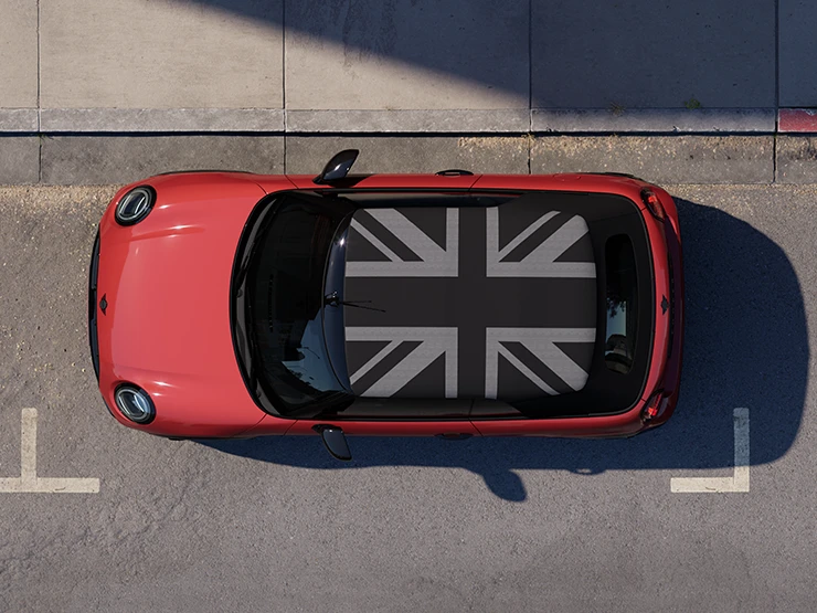 Ülaltvaade: tänaval seisev MINI Cooper Convertible värvitoonis Chili Red ja MINI Yours’i katusega